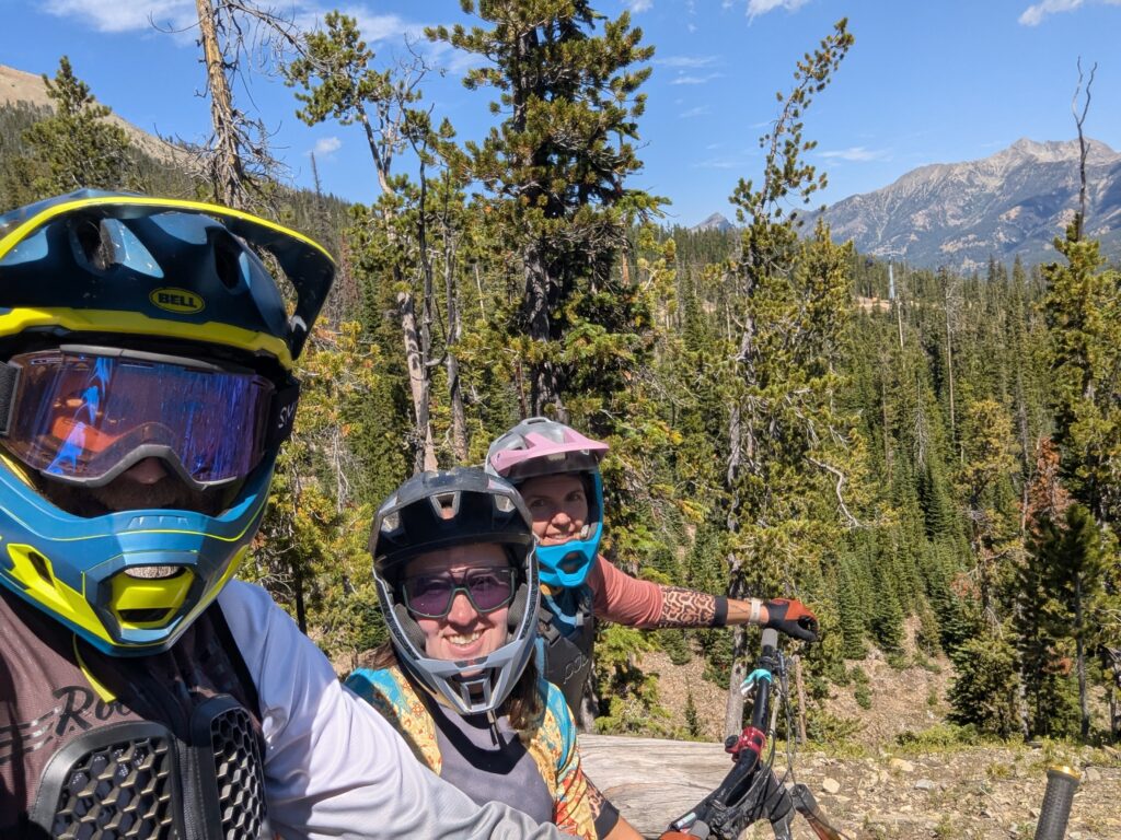 Three people mountain biking in the forest